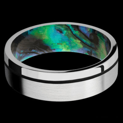7 mm wide/Flat/14K White Gold band with one 0.5 mm Off Center inlay of Black also featuring a Abalone sleeve.