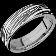7 mm wide/Flat/Titanium band with one 6 mm Centered inlay of Zirconium with a laser carved Zebra pattern.