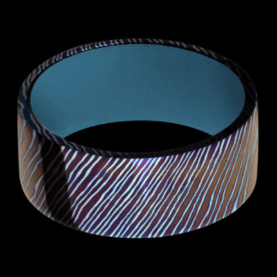 9 mm wide Flat Titanium Damascus band featuring a Royal Blue sleeve.