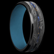 7 mm wide/Beveled/Zirconium band featuring inlays of Forged Carbon Fiber and Blue Tiger Eye also featuring a Royal Blue sleeve.